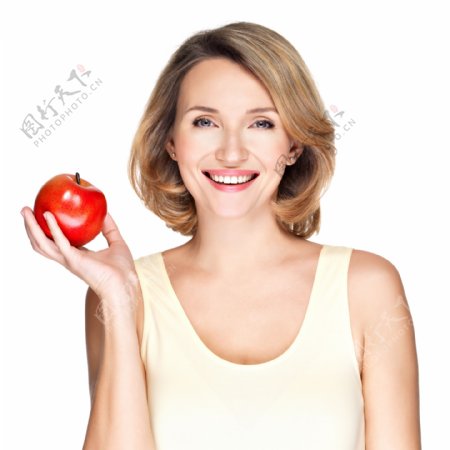 手拿苹果的健康牙齿女性图片