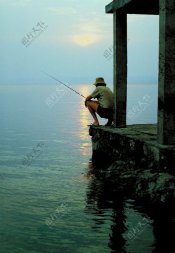 早晨海边钓鱼的人图片